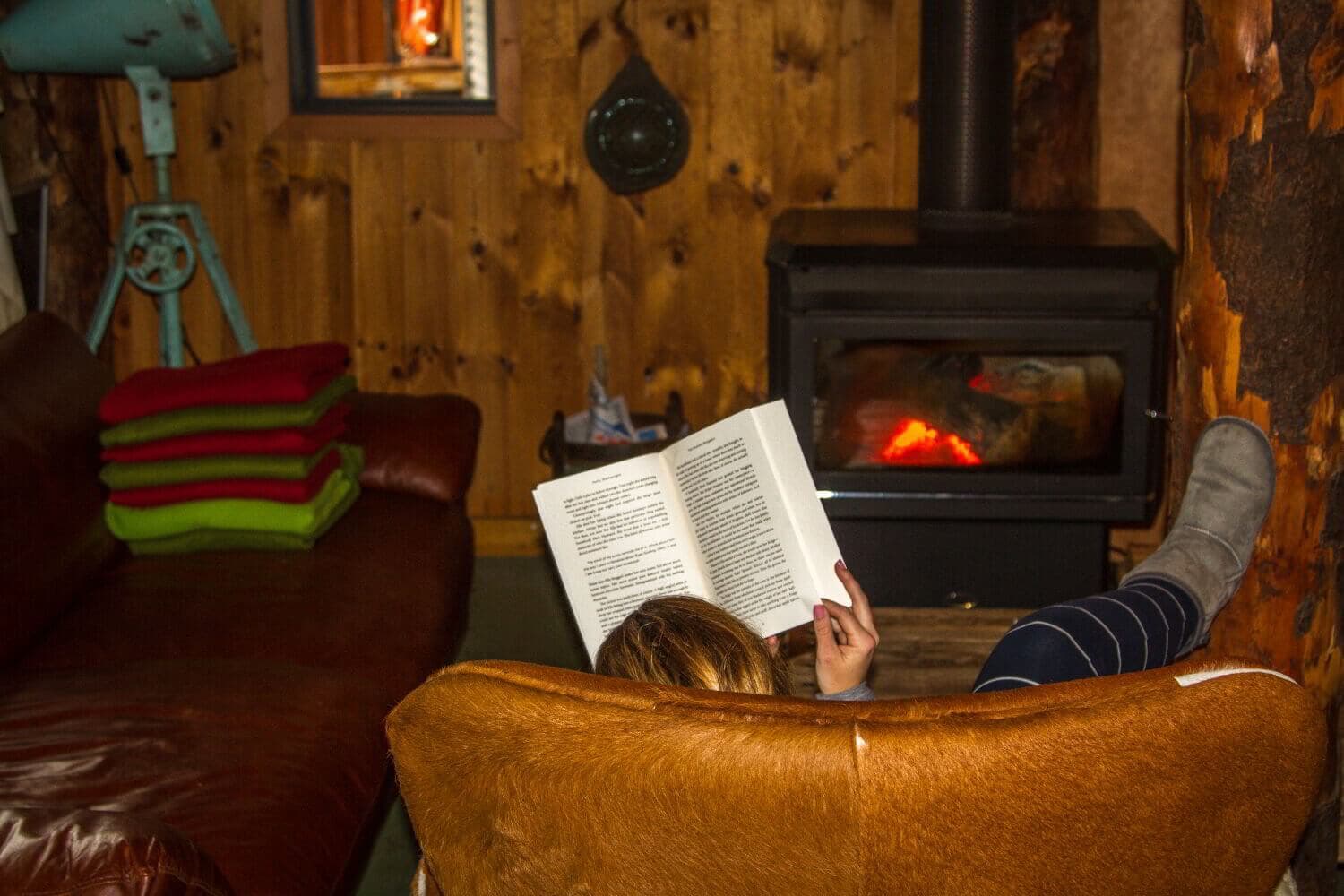 bruny-island-lodge-dylan-reading-by-fire-1500x1000-IMG1177