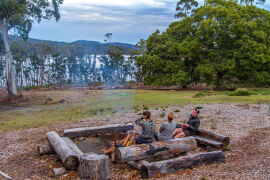 relaxing by the outdoor fire at Bruny Island Lodge