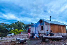 relaxing by the outdoor fire at Bruny Island Lodge